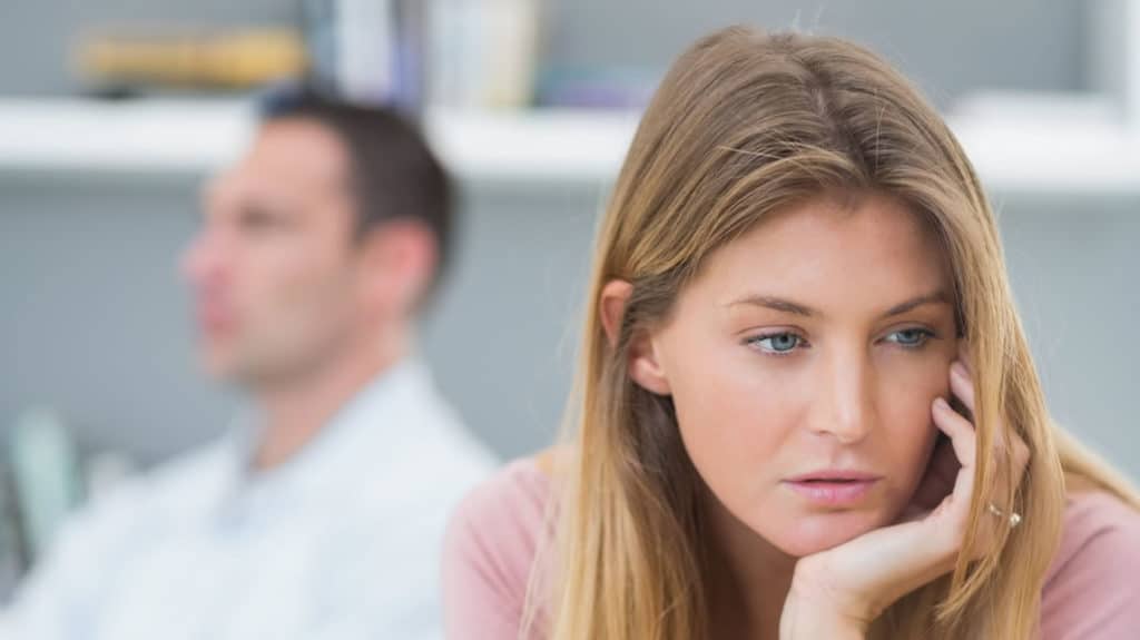 Disillusioned couple look expressionless in different directions