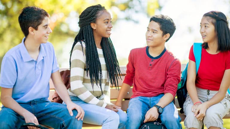 Friends talking on a bench