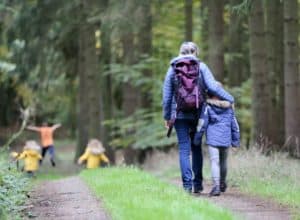 Grandmother walking with grandchildren in forest