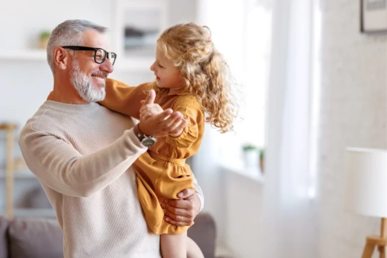 Passing on a spiritual inheritance of joy by dancing with his grand daugher in his arms